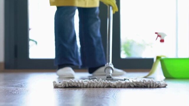Home, spring cleaning and person with mop, floor or bucket with chemical for disinfection or chores. House and prevention of germs in apartment, routine and removal of dirt with equipment at home