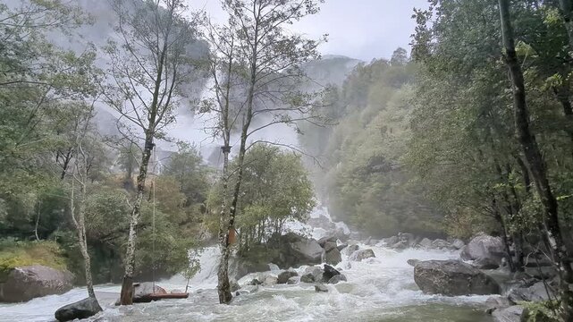 Dramatic view of the thundering Foroglio Waterfall, Cascata di Foroglio, crashing down a cliff in Val Bavona, Ticino, Switzerland, ideal for nature travel guides.