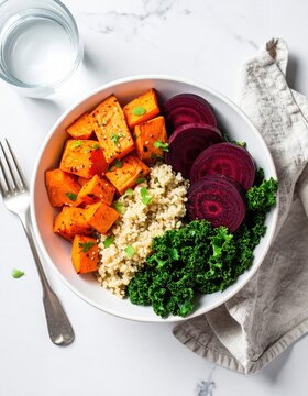 Vibrant bowl with roasted sweet potatoes, quinoa, kale, and sliced beets