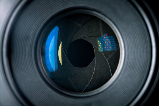 50mm camera lens with aperture blades and light reflections on the glass