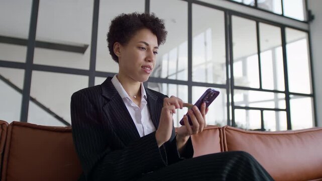 Business Woman Celebrating Achievement With Smartphone