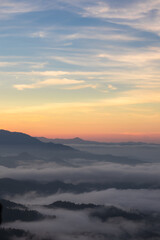 Obraz premium Sunrise Over Misty Mountains