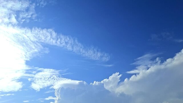 Blue Sky With White Cumulus and Cirrus Clouds