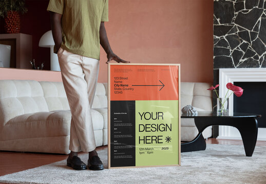 Mockup Of Man Holding Customized Framed Poster
