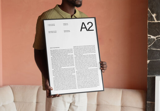 Mockup Of Man Holding Customized A2 Artwork
