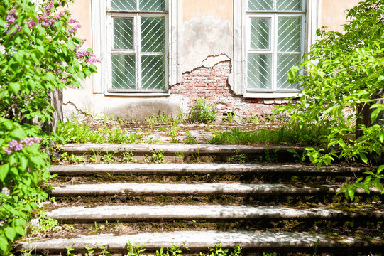 Abandoned facade with weathered stairs