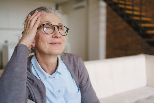 Happy senior woman portrait looking away with copy space, elderly lifestyle, positive emotion, natural light, healthy aging, confidence, peaceful expression and modern retirement concept