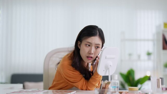 Asian businesswoman talking phone call working office desk multitask professional woman discuss project mobile conversation manage document review bright