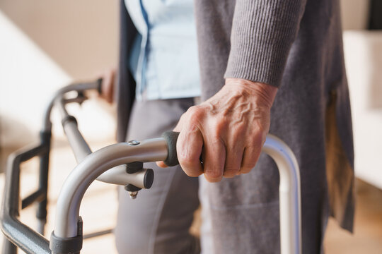 Close up of senior woman hands holding walker at home, elderly mobility support, rehabilitation, healthcare concept, independence, aging and assistive device use