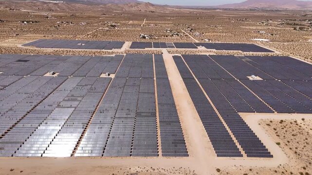 Aerial view of a vast solar panel array in the arid landscape of Lucerne Valley, California, United States.