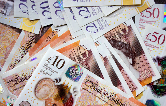 British pounds close-up on a chessboard background. National currency of Great Britain