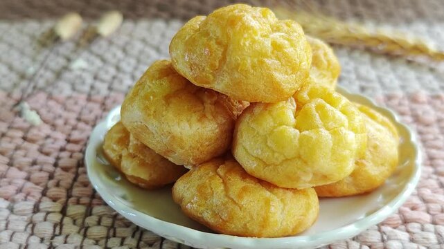 Eclairs or cream puffs on a plate.