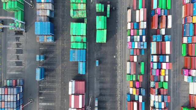 Aerial top view container terminal with colorful cargo stacks and global logistics operation
