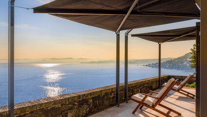 Fototapeta premium Stunning Balcony View of Calm Lake at Sunset with Relaxing Chairs