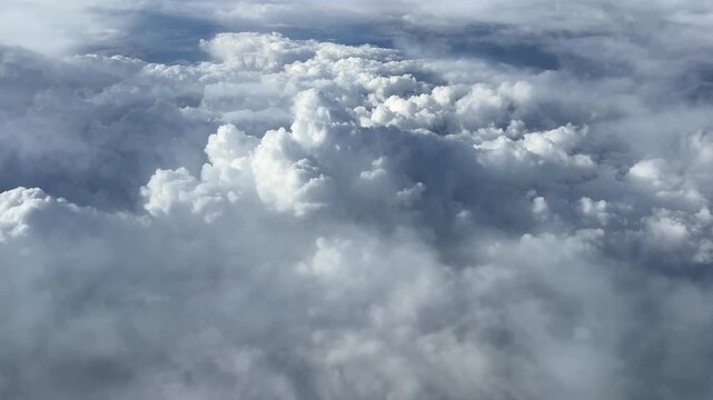 Tranquil view of flying over white puffy clouds slowly 