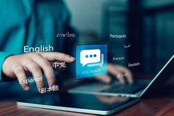 Businesswoman using laptop and tablet with multilingual feedback interface for online communication, language translation, customer support, global business and digital interaction concept. © ภัทรชัย รัตนชัยวงค์