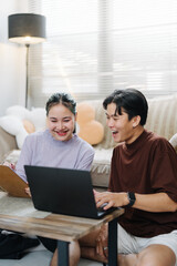 Fototapeta premium sian Man Laughing Loud at Laptop with Woman Partner, Business Win Portrait