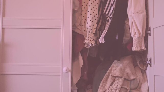 overcrowded wardrobe packed with clothes hangers, excess garments limited space, messy storage, decluttering, overconsumption lifestyle hoarding behavior accumulation, organization mental overload