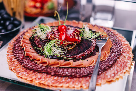 Charcuterie meat platter with cured meats and garnishes for party buffet and catering display