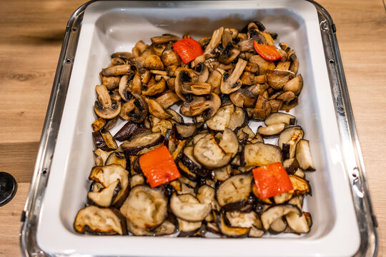 Roasted mushrooms and eggplant with red peppers in a buffet serving tray