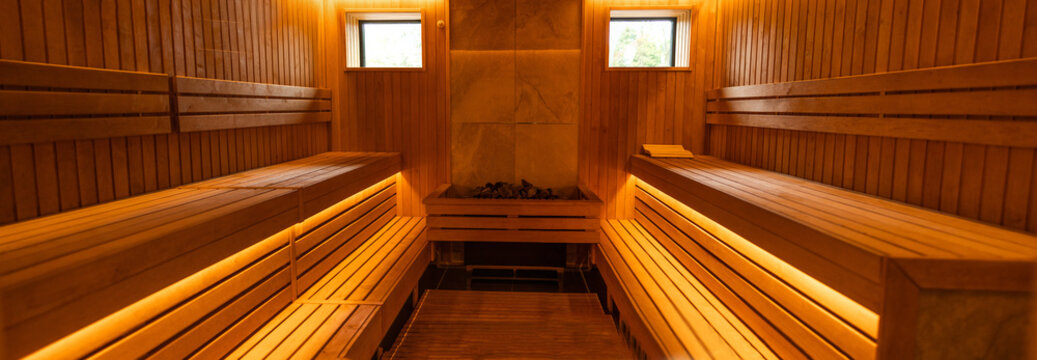 Relaxing wooden sauna interior with warm lighting and benches in a spa retreat