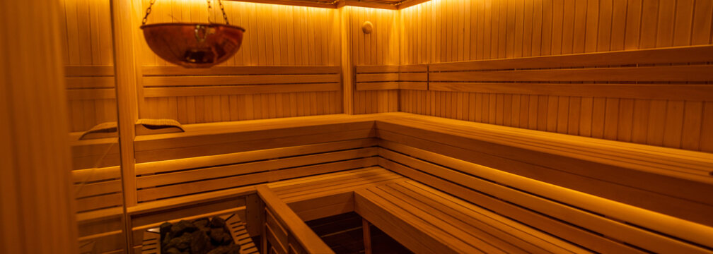 Relaxing wooden sauna interior with warm lighting and bench seating in a spa setting