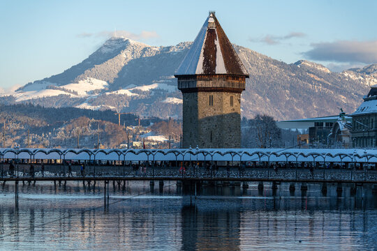 The Water Tower framed against the snow-capped peaks of Mount Pilatus in winter, Switzerland