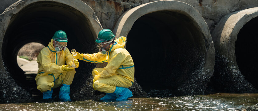 Environmental Workers Inspecting Polluted Wastewater Drainage Tunnel In Coastal Industrial Area During Contamination Monitoring Process