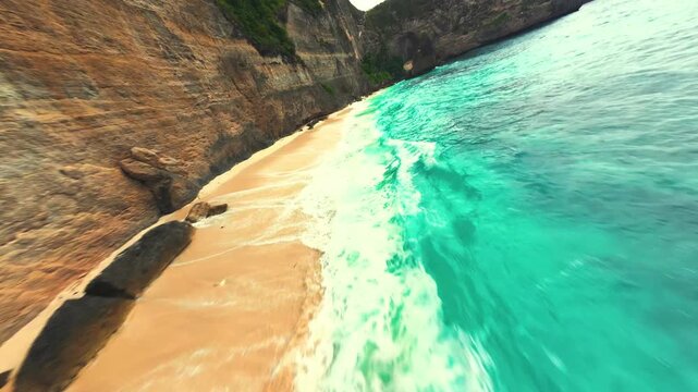 Aerial perspective of a hidden tropical beach with crystal clear turquoise water