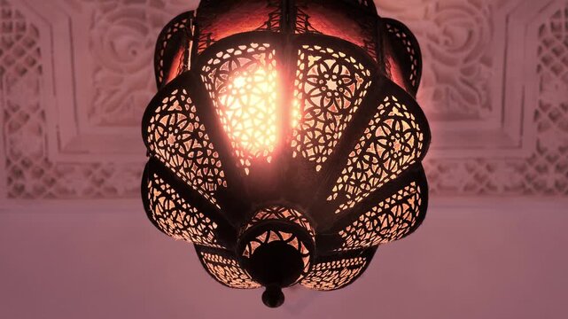 Traditional Moroccan lantern with ornate design lights up and goes out in dark room, decorative artistry lighter, oriental lamp, , hard shadows on wall cultural african craftsmanship, warm spectrum