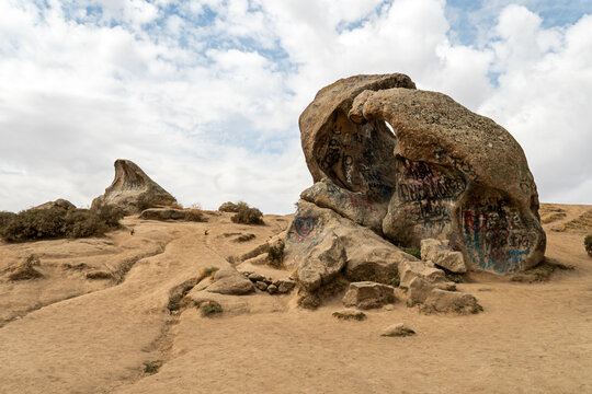 scenic hillside slope with large scattered rocks and boulders in Uzbekistan, featuring a beautiful mountain landscape.