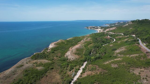 Aerial view of the rugged Kaliakra cliffs and lush green hills along the Black Sea coastline in Dobrich Province, Bulgaria.