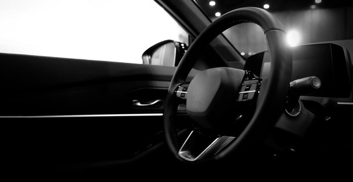 EV Car steering wheel. Modern car interior with luxury steering wheel dashboard and digital monitor controls. Steering wheel and automotive cabin. Car technology comfort and premium design in EV car.
