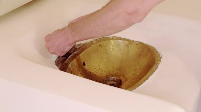 young man washing in Rustic brass sink, morning skincare routine in Moroccan-style interior, Self-care and mindfulness, basic hygiene and cultural touch in Morocco