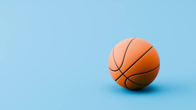 Basketball Ball Rolling Slowly from Left and from Right and Stopping on Clean Blue Background with Copy Space