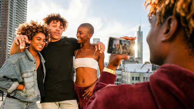 Diverse friends posing rooftop photo