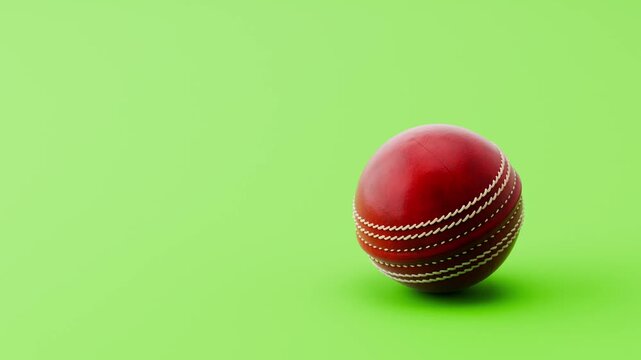 Cricket Ball Rolling Slowly from Left and from Right and Stopping on Clean Green Background with Copy Space