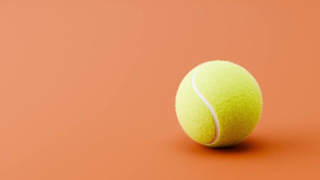 Tennis Ball Rolling Slowly from Left and from Right and Stopping on Clean Brown Red Background with Copy Space