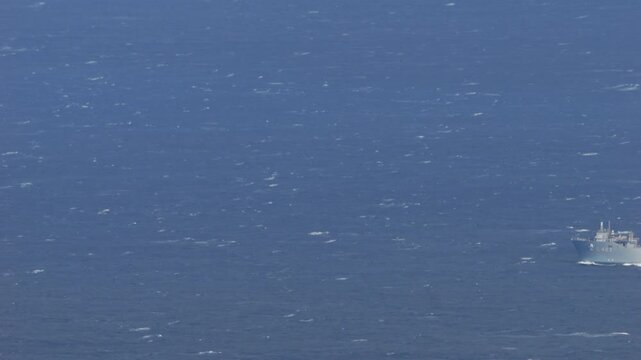 4K telephoto video of Turkish naval vessel TCG Sancaktar (L403) sailing through the Aegean Sea between Kea and Kythnos islands, Greece, filmed on 03 May 2026 in windy maritime conditions with visible 