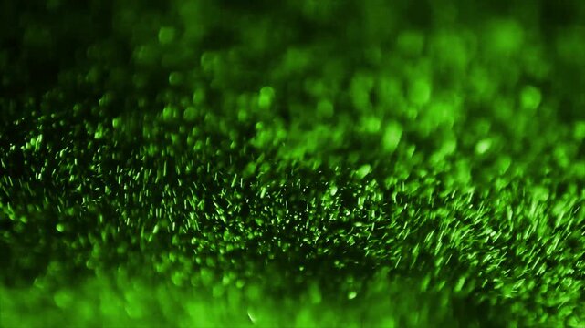 Close-up footage of glowing green bioluminescent algae in motion underwater