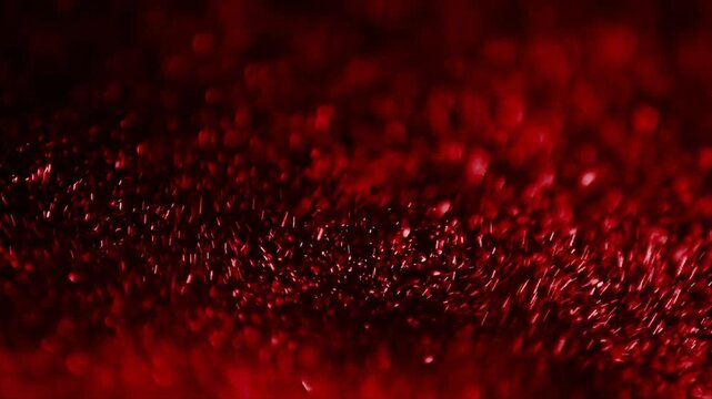 Close-up footage of red glowing embers burning in darkness with smoke rising