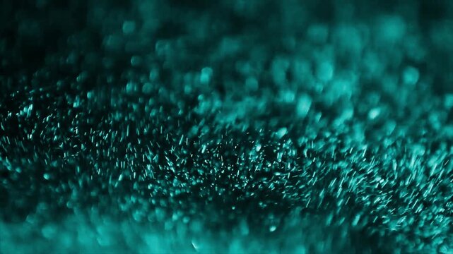 Close-up abstract motion of flowing water with blue and green light reflections