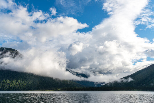 Canada, BC, Bowron Lake Provincial Park.  Large cumulous clouds shroud the surrounding hills at Isaac Lake.  Bowron Lakes, on the western slopes of the Cariboo Mountains is a popular canoe circuit.