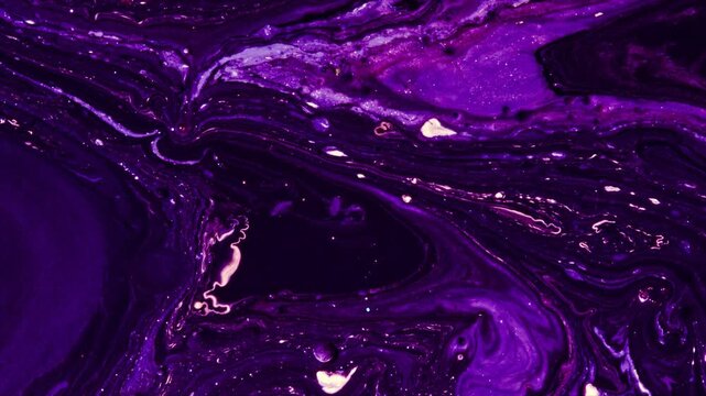 Close-up footage of melting purple and black wax with smoke and dripping texture in low light