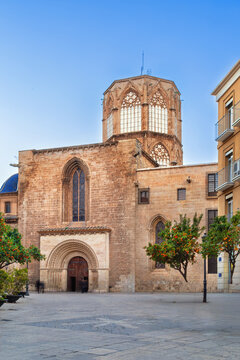 Cathedral portal from Carrer del Palau in Valencia, Spain. Perspective view, evening light, clear sky, ancient stone