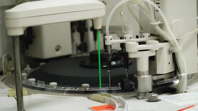 Automated robotic pipetting system precisely dispenses blue liquid into vials in a sterile lab.
