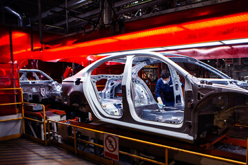 Naklejka premium Asian workers are working on an automobile body production line factory.