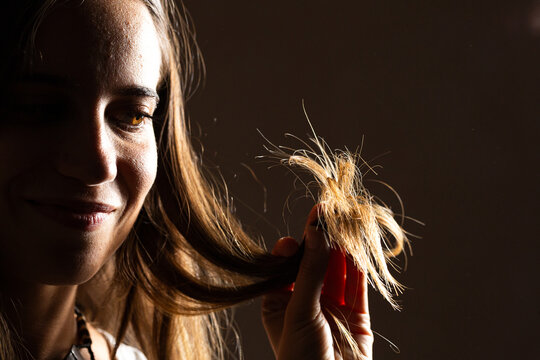 Woman showing damaged hair with split ends