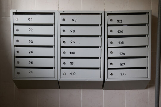 Gray metal mailboxes in the entrance of the cell for mail and letters