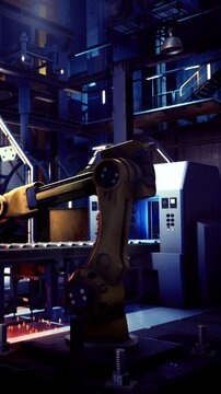 An advanced robotic arm assists in manufacturing tasks inside a dark, high tech factory. Bright lights illuminate the workstation, highlighting the intricate machinery around.
